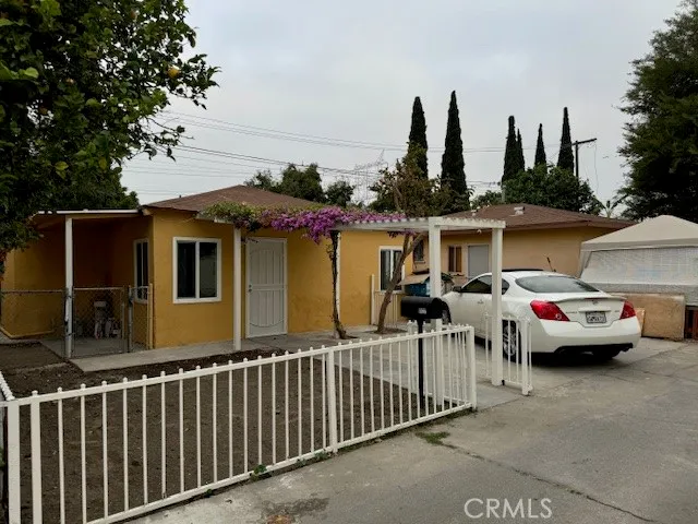 a couple of cars parked in front of a house