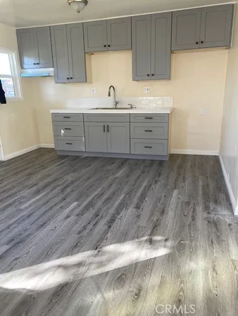 a kitchen with wooden cabinets and sink