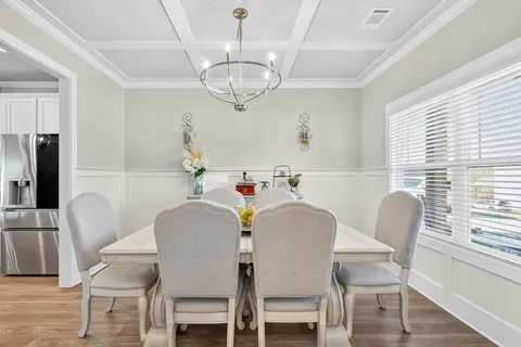 a dining room with furniture and wooden floor