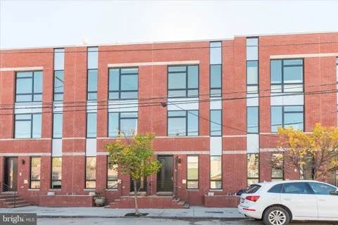 a front view of a residential apartment building with a street