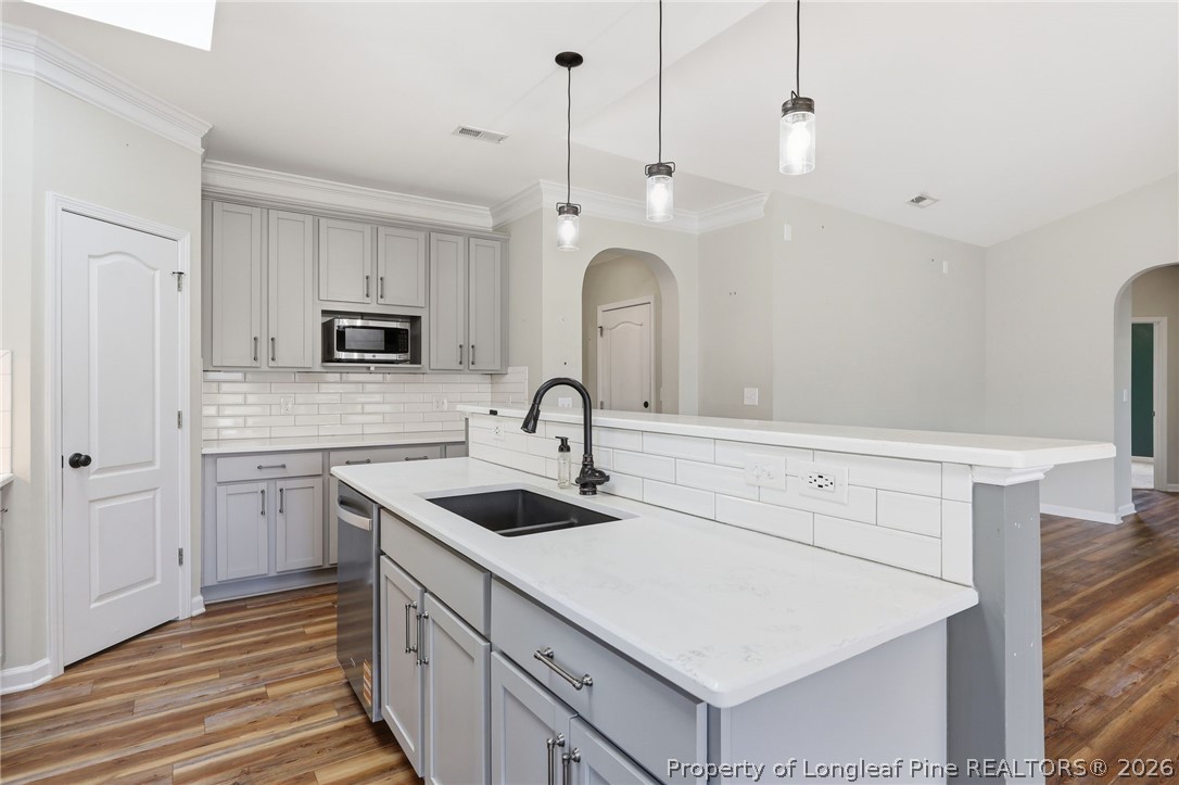 33 Colonist Place Cameron, NC 28326 - Photo 17 of 47 a kitchen with kitchen island a sink appliances and cabinets