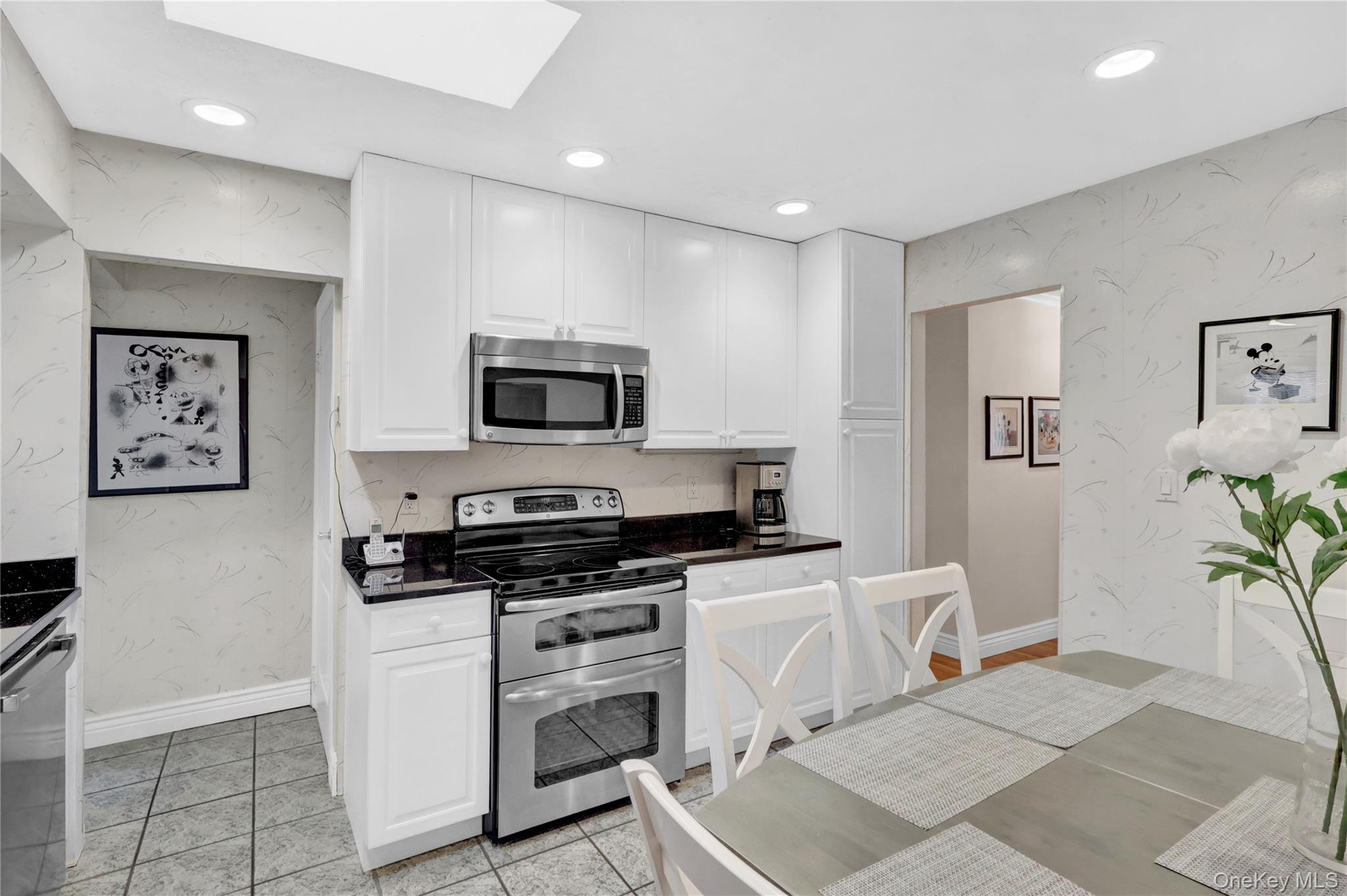 46 Kalda Lane Plainview, NY 11803 - Photo 16 of 30 a kitchen with granite countertop a stove a sink and a refrigerator