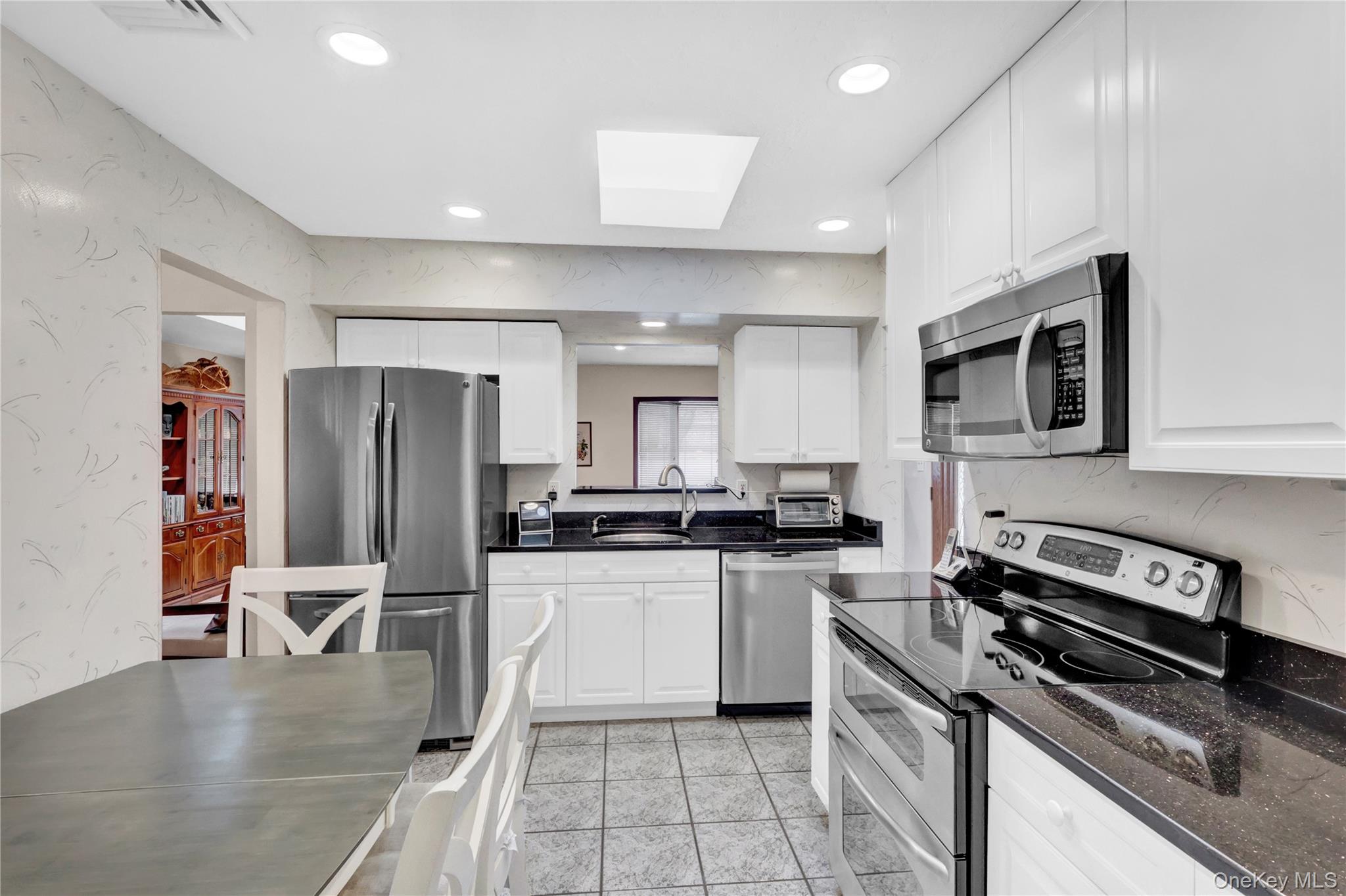 46 Kalda Lane Plainview, NY 11803 - Photo 19 of 30 a kitchen with stainless steel appliances a stove a sink and a refrigerator