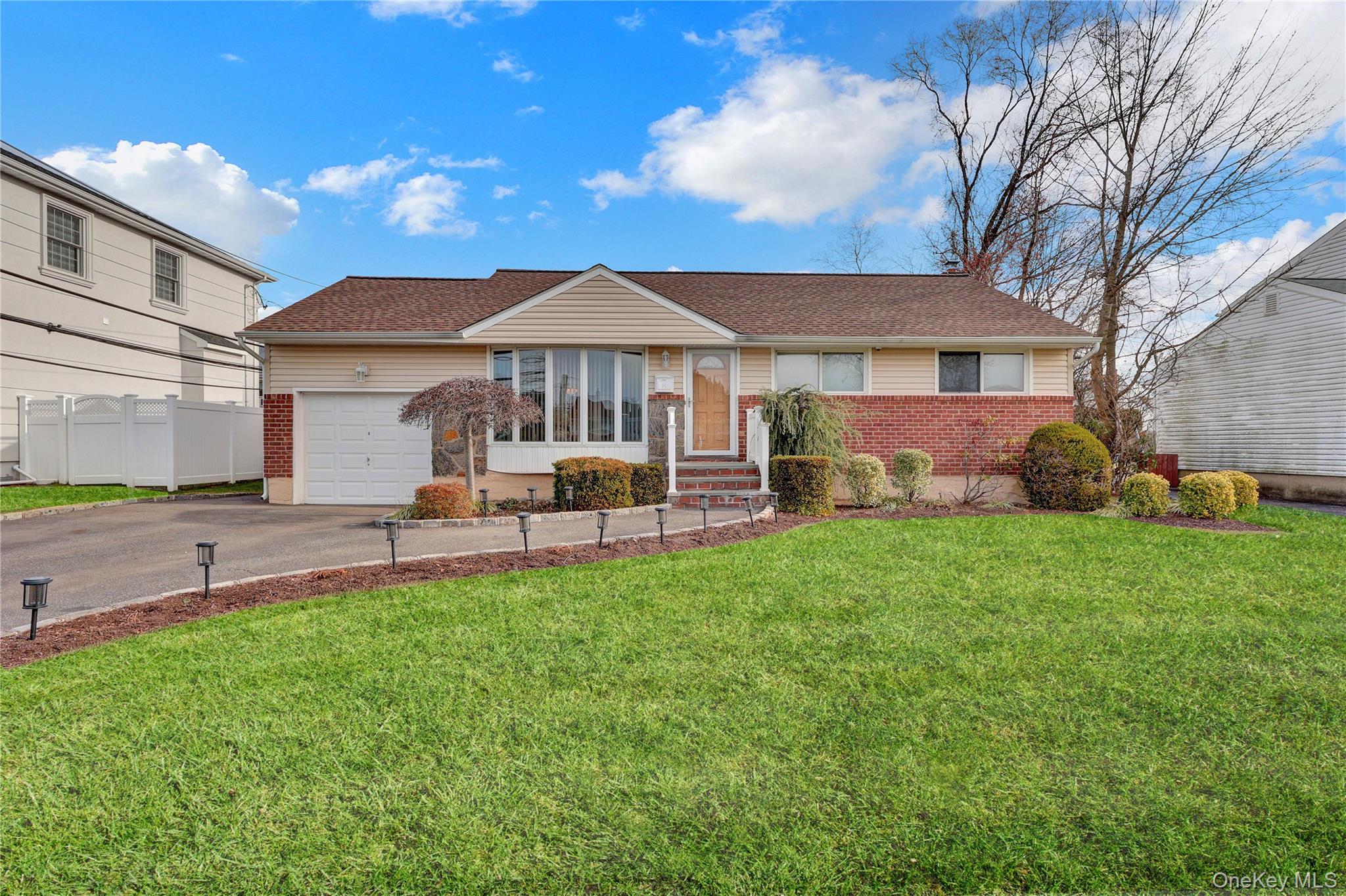 46 Kalda Lane Plainview, NY 11803 - Photo 2 of 30 a front view of a house with a garden and patio