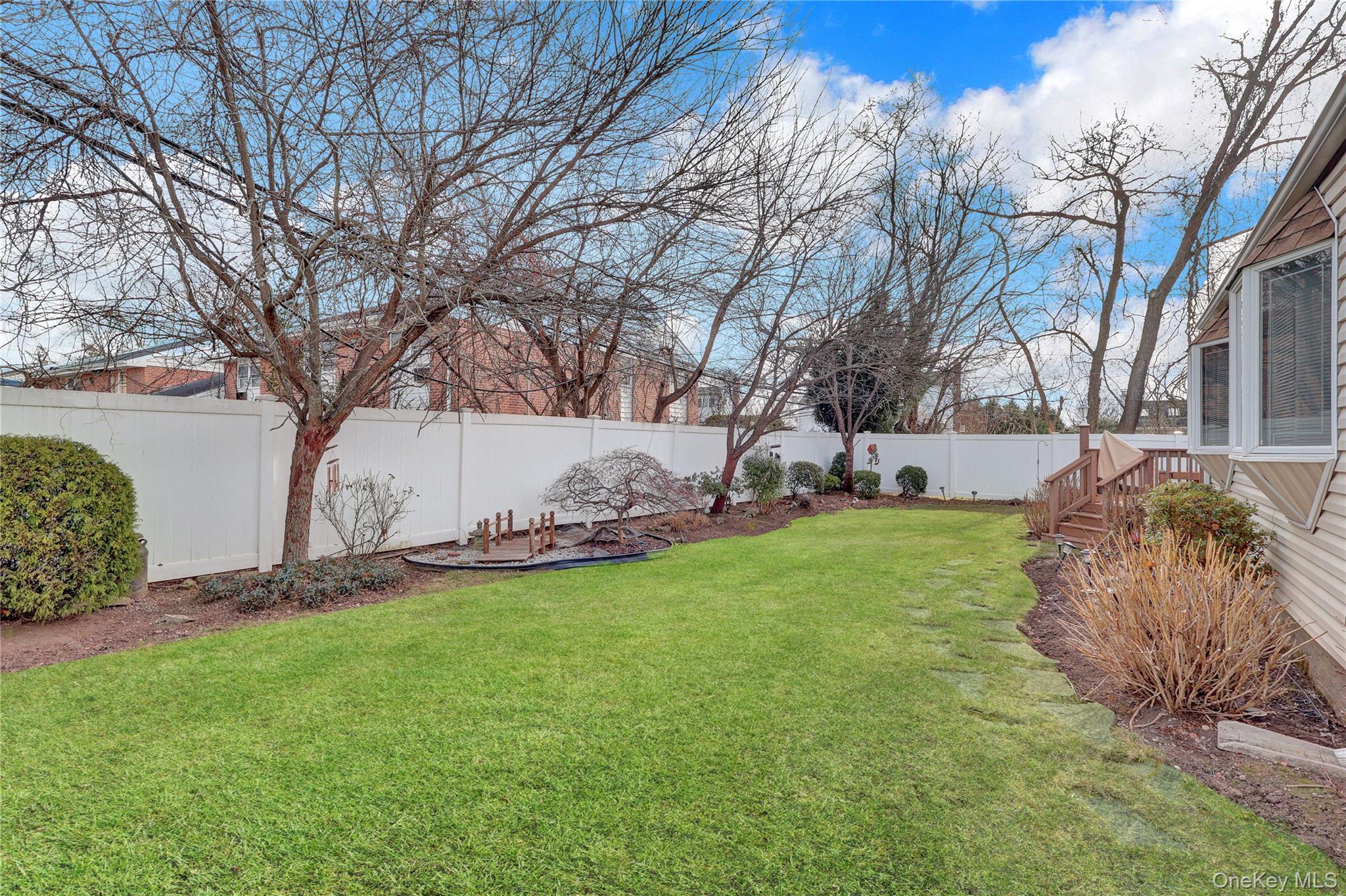 46 Kalda Lane Plainview, NY 11803 - Photo 4 of 30 a view of a backyard with large trees