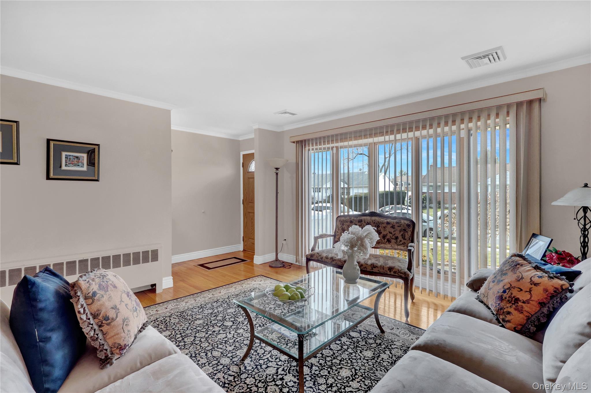 46 Kalda Lane Plainview, NY 11803 - Photo 10 of 30 a living room with furniture and a floor to ceiling window