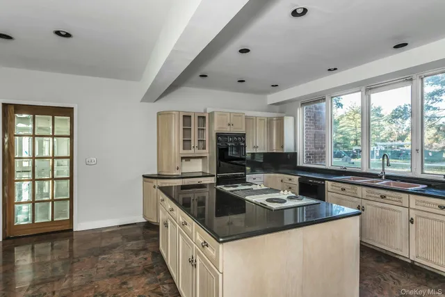 a kitchen that has a sink and a stove in it