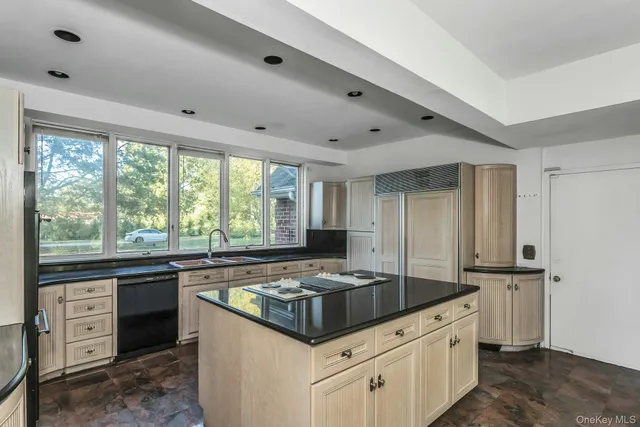 a kitchen with granite countertop a sink stove and cabinets