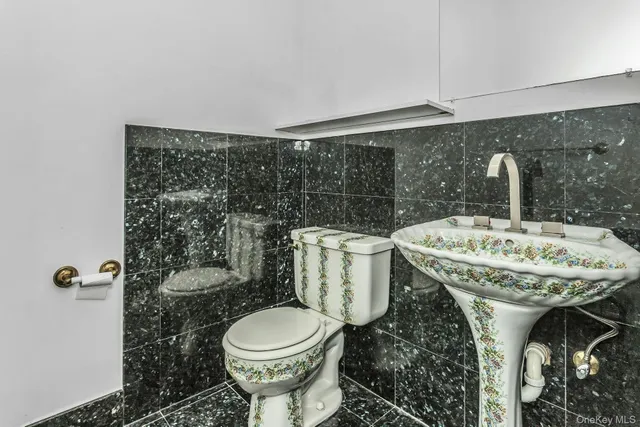 a bathroom with a sink a toilet and a mirror