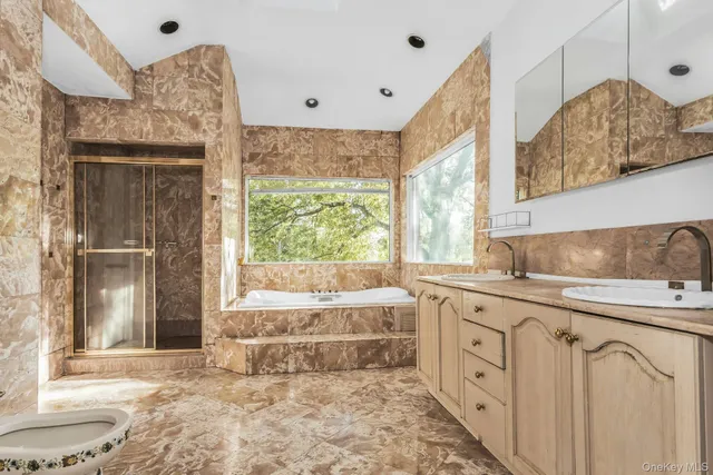 a spacious bathroom with a sink mirror and a bathtub