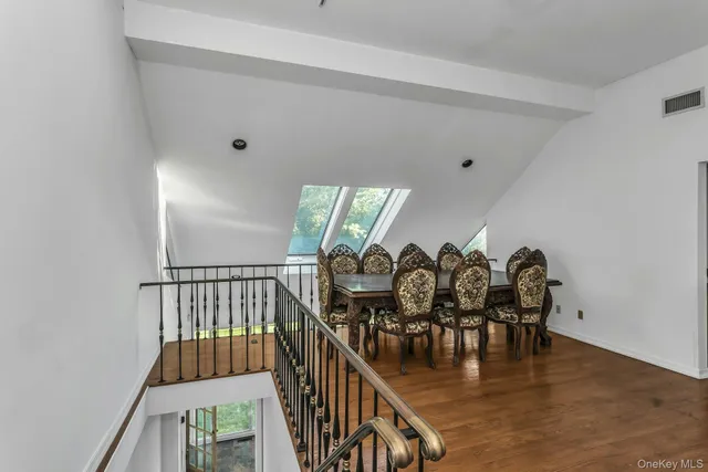 a dining room with furniture and wooden floor