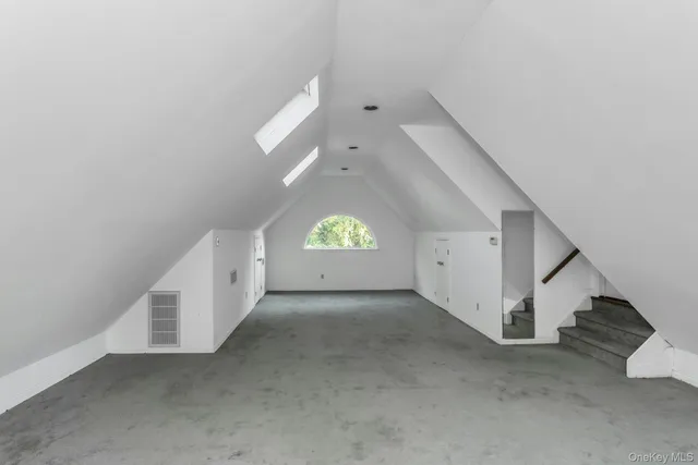 an empty room with a windows and ceiling fan view