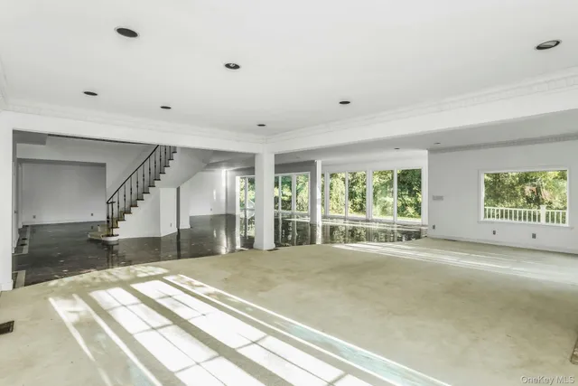 a spacious bedroom with a large bed and a large window