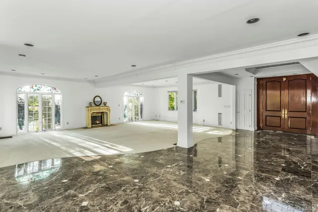 a spacious bedroom with a bed and a large window