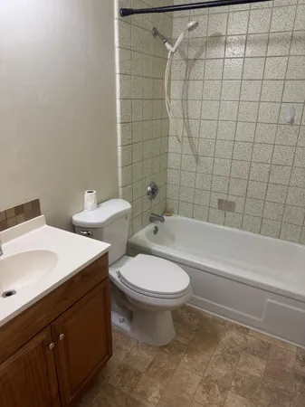 a bathroom with a toilet a sink and bathtub