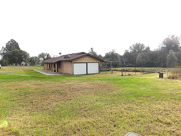 a house view with swimming pool in front of it