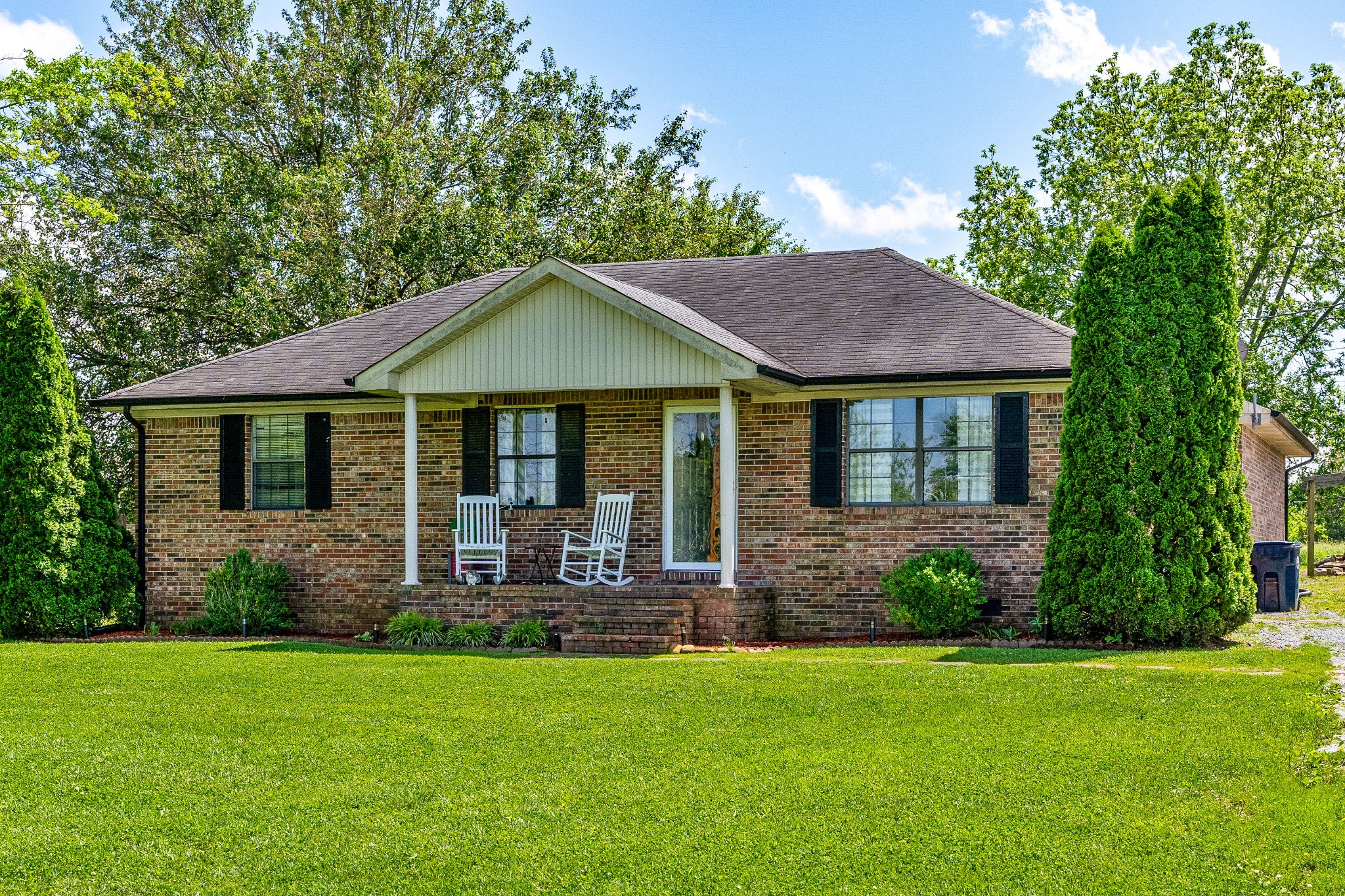 409 Kendra Drive Smithville, TN 37166 - Photo 3 of 27 a house with garden in front of it
