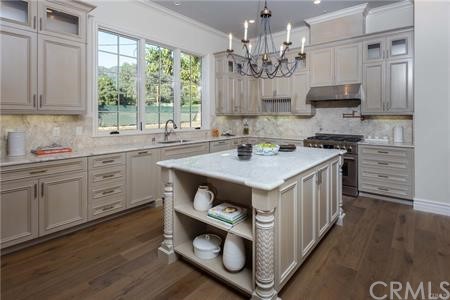 18 Dovetail Lane Bradbury, CA 91008 - Photo 26 of 40 a kitchen that has a lot of cabinets in it and wooden floor