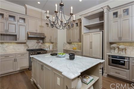 18 Dovetail Lane Bradbury, CA 91008 - Photo 27 of 40 a kitchen with stainless steel appliances granite countertop a sink a stove and a refrigerator