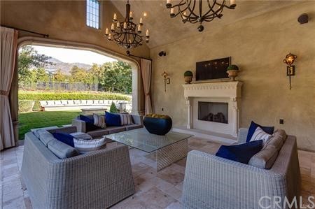 18 Dovetail Lane Bradbury, CA 91008 - Photo 28 of 40 a living room with furniture a fireplace and a floor to ceiling window