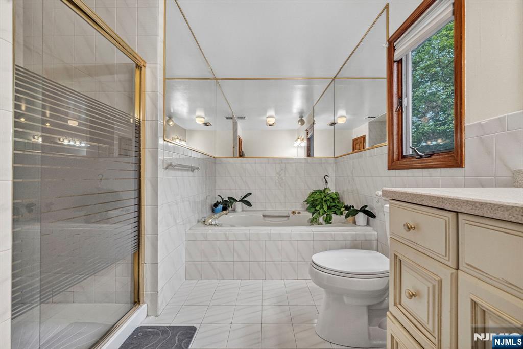 5110 Berkshire Valley Road Oak Ridge, NJ 07438 - Photo 26 of 49 a bathroom with a sink a toilet and shower