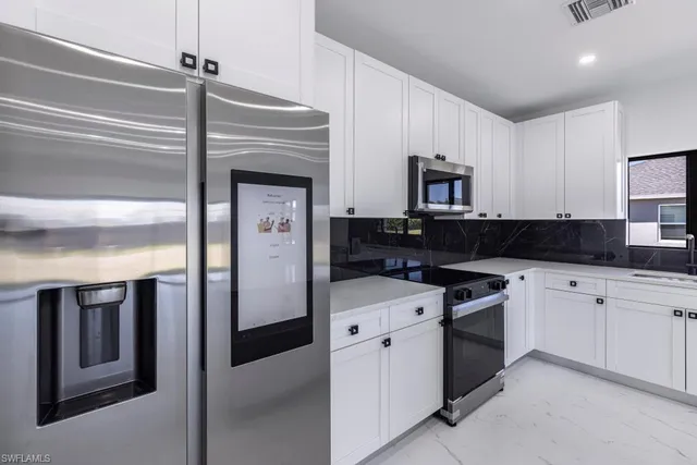 a kitchen with a refrigerator and a sink