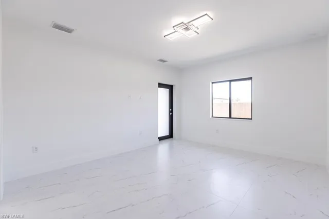 a kitchen with stainless steel appliances granite countertop a stove a refrigerator and a microwave