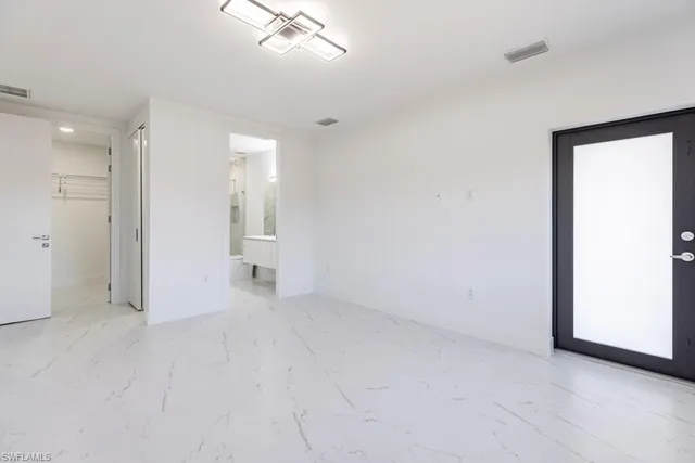 a kitchen with stainless steel appliances granite countertop a stove and a refrigerator