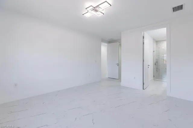 an empty room with windows and closet