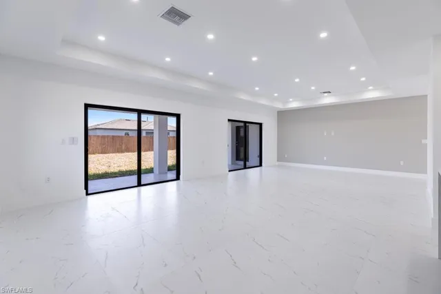 a large kitchen with stainless steel appliances a large counter top and oven