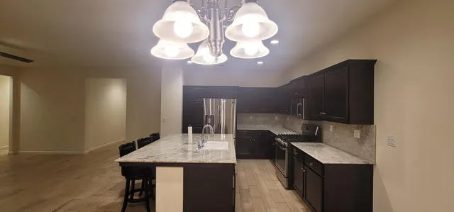 a kitchen with a counter space a sink and cabinets