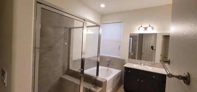 a bathroom with a double vanity sink and mirror