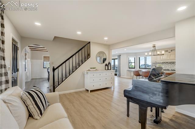 3405 Spaatz Road Monument, CO 80132 - Photo 12 of 47 Living room with light hardwood / wood-style flooring and an inviting chandelier