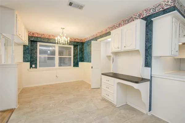 a view of kitchen with cabinets