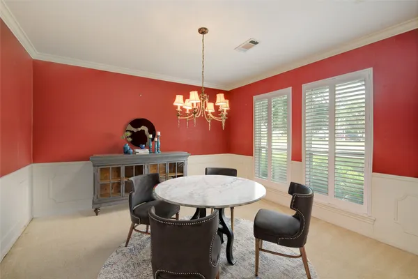 a dining room with furniture and window