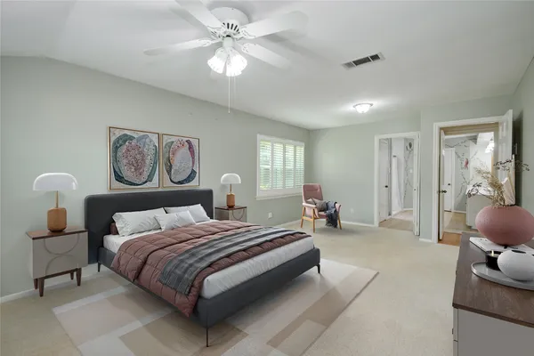 a spacious bedroom with a bed a couch and a chandelier