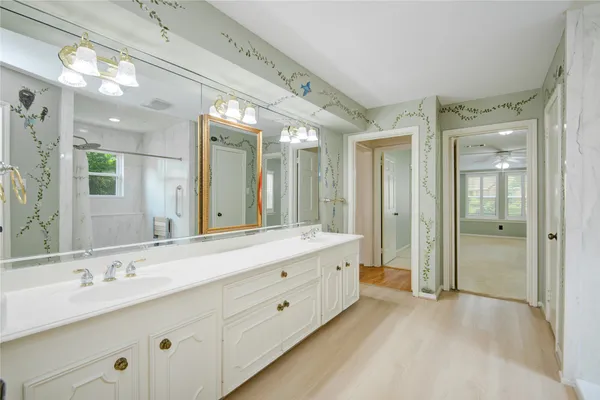a spacious bathroom with a double vanity sink mirror and double