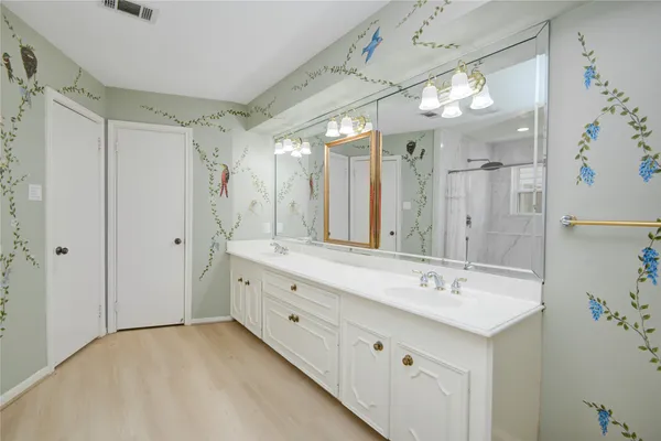 a bathroom with a double vanity sink mirror double and shower