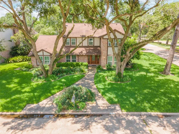 a aerial view of a house with a yard and potted plants