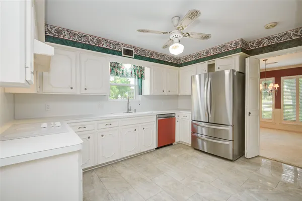 a kitchen with stainless steel appliances a refrigerator sink and cabinets