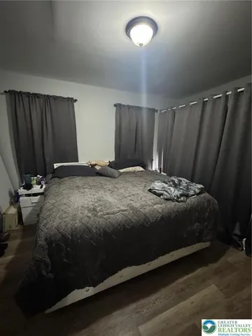 a bedroom with a bed and mirror