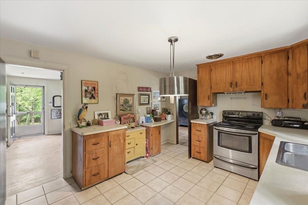 99 Brook Road Sharon, MA 02067 - Photo 13 of 37 a kitchen with stainless steel appliances granite countertop a stove a sink and a refrigerator