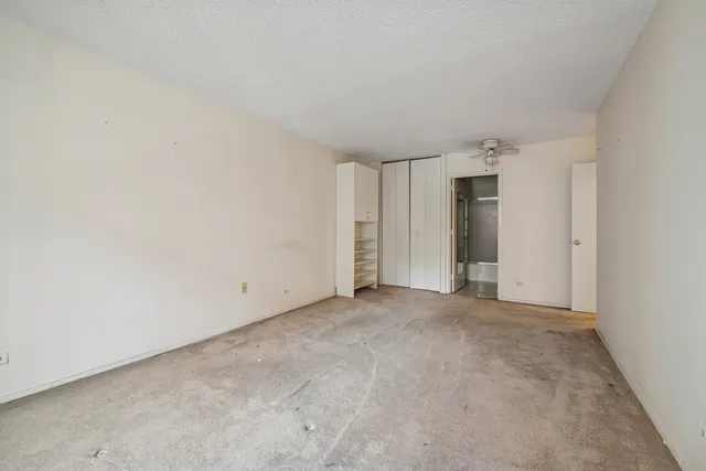 a living room with furniture a flat screen tv and a window