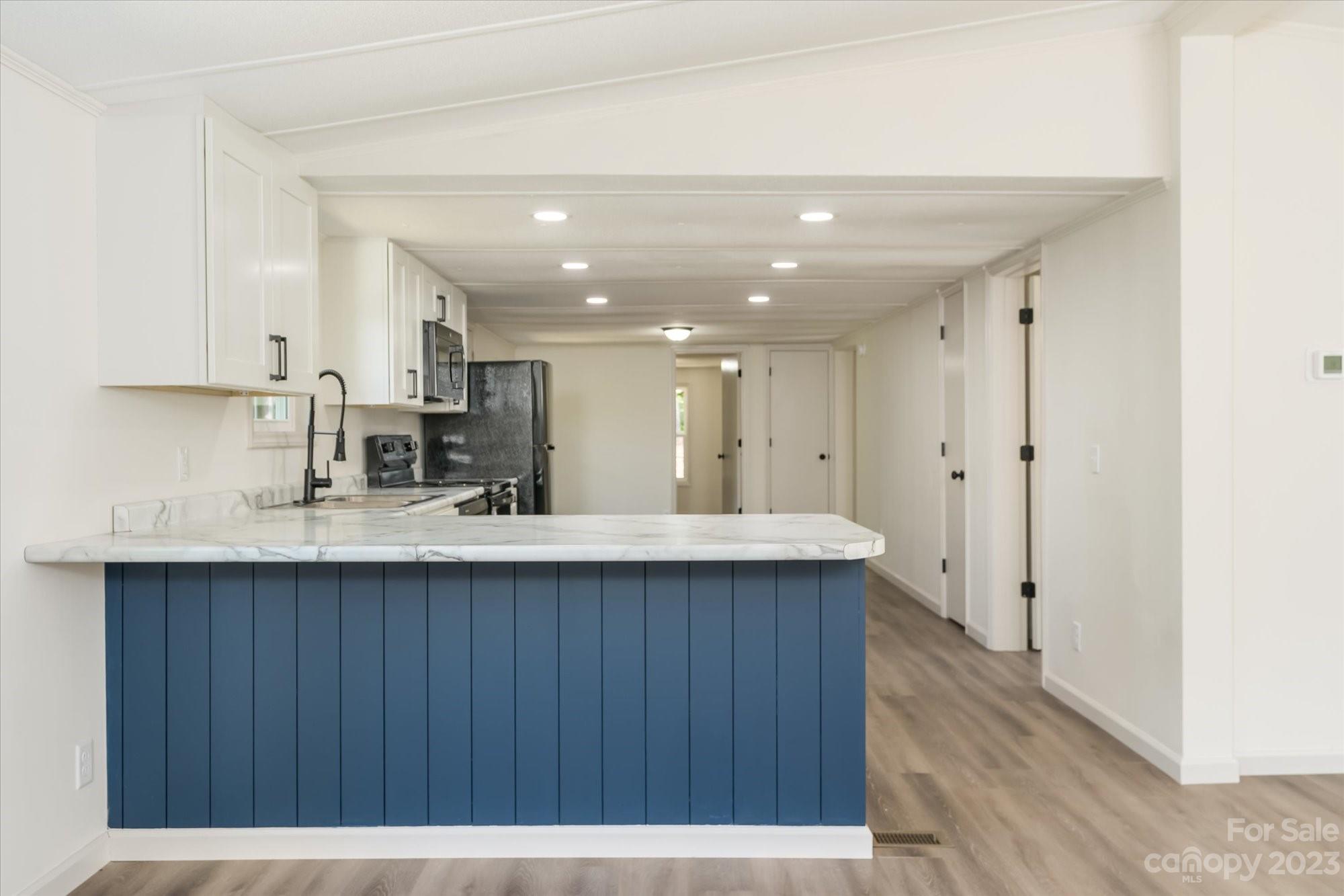175 King Stepp Road Mill Spring, NC 28756 - Photo 11 of 46 a kitchen with stainless steel appliances a sink stove and cabinets