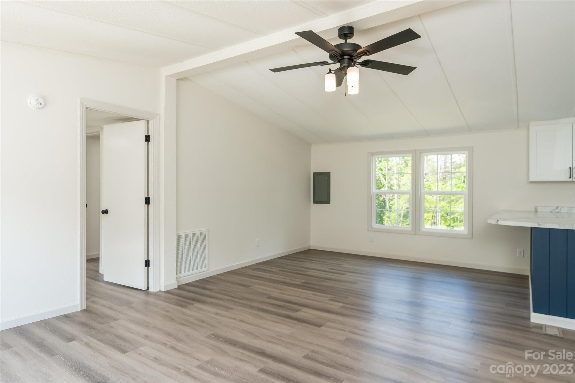175 King Stepp Road Mill Spring, NC 28756 - Photo 15 of 46 a view of an empty room with window and wooden floor