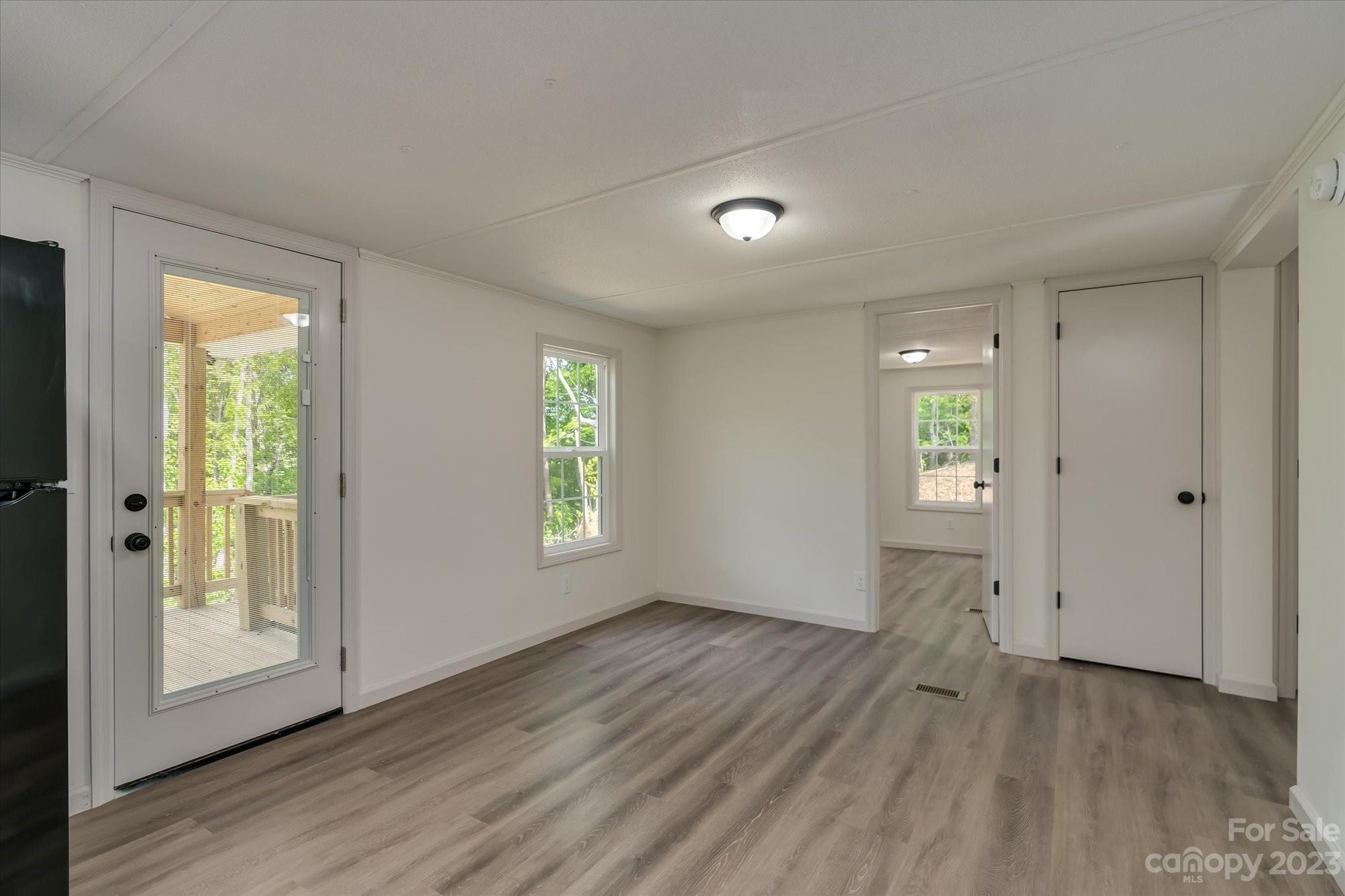 175 King Stepp Road Mill Spring, NC 28756 - Photo 20 of 46 an empty room with wooden floor and windows