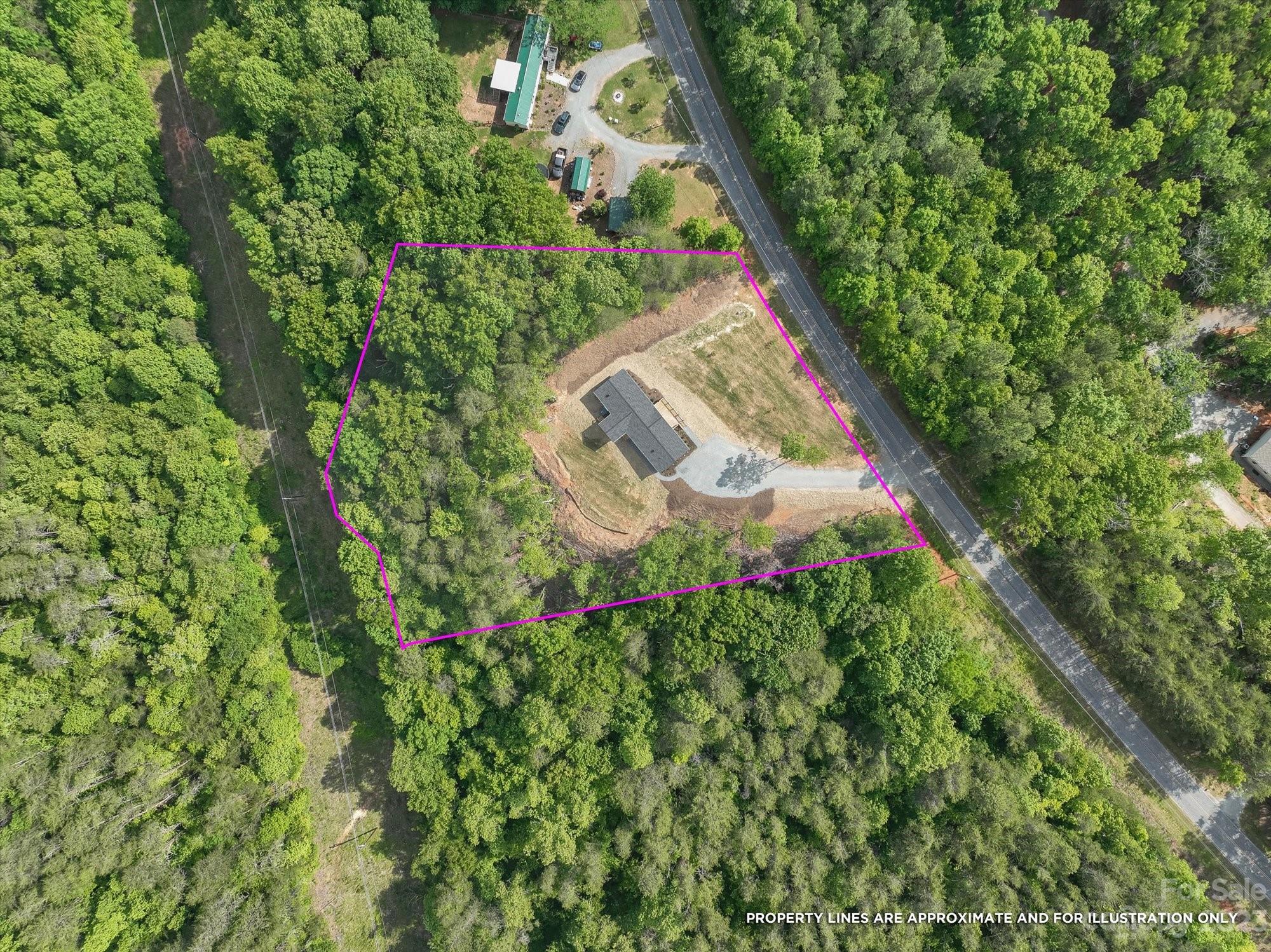 175 King Stepp Road Mill Spring, NC 28756 - Photo 2 of 46 an aerial view of a house with a yard and garden