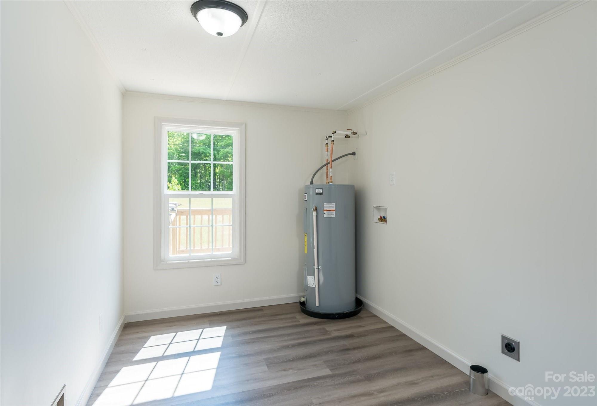 175 King Stepp Road Mill Spring, NC 28756 - Photo 26 of 46 an empty room with wooden floor and windows