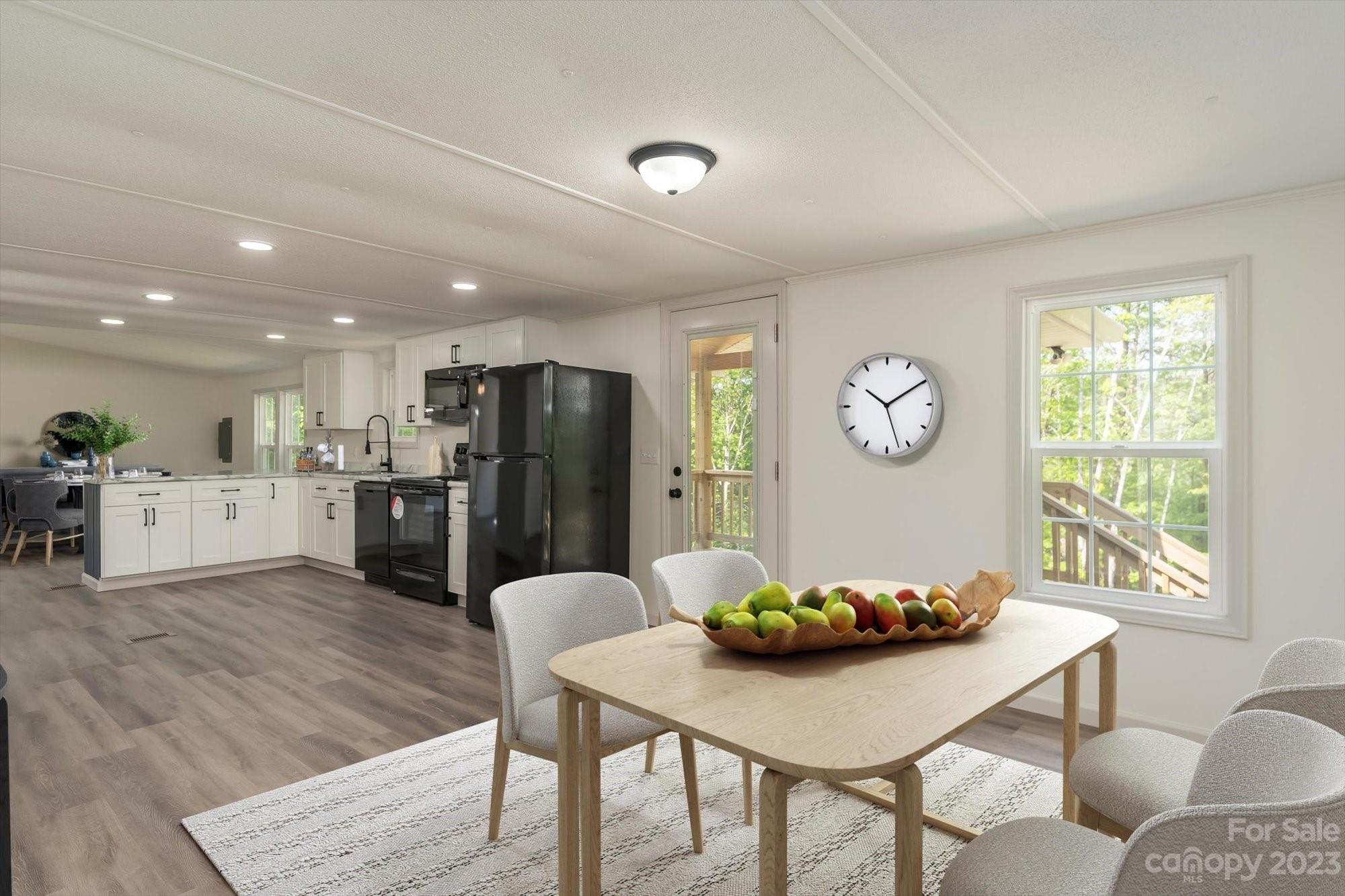 175 King Stepp Road Mill Spring, NC 28756 - Photo 43 of 46 a living room with stainless steel appliances furniture a dining table and a refrigerator