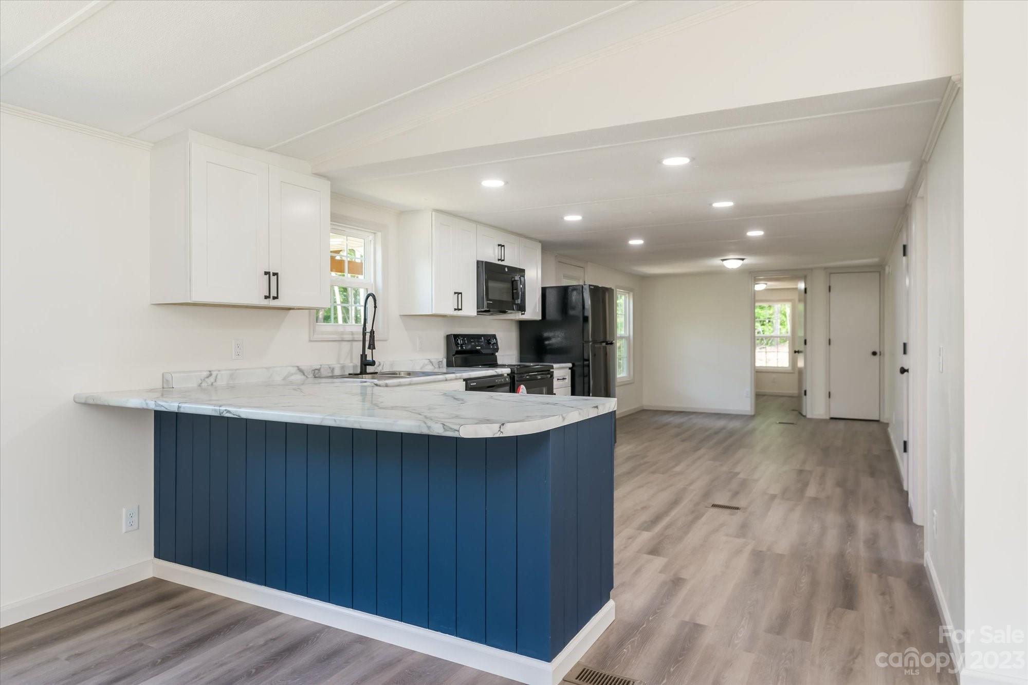 175 King Stepp Road Mill Spring, NC 28756 - Photo 7 of 46 a kitchen with stainless steel appliances a sink stove and cabinets